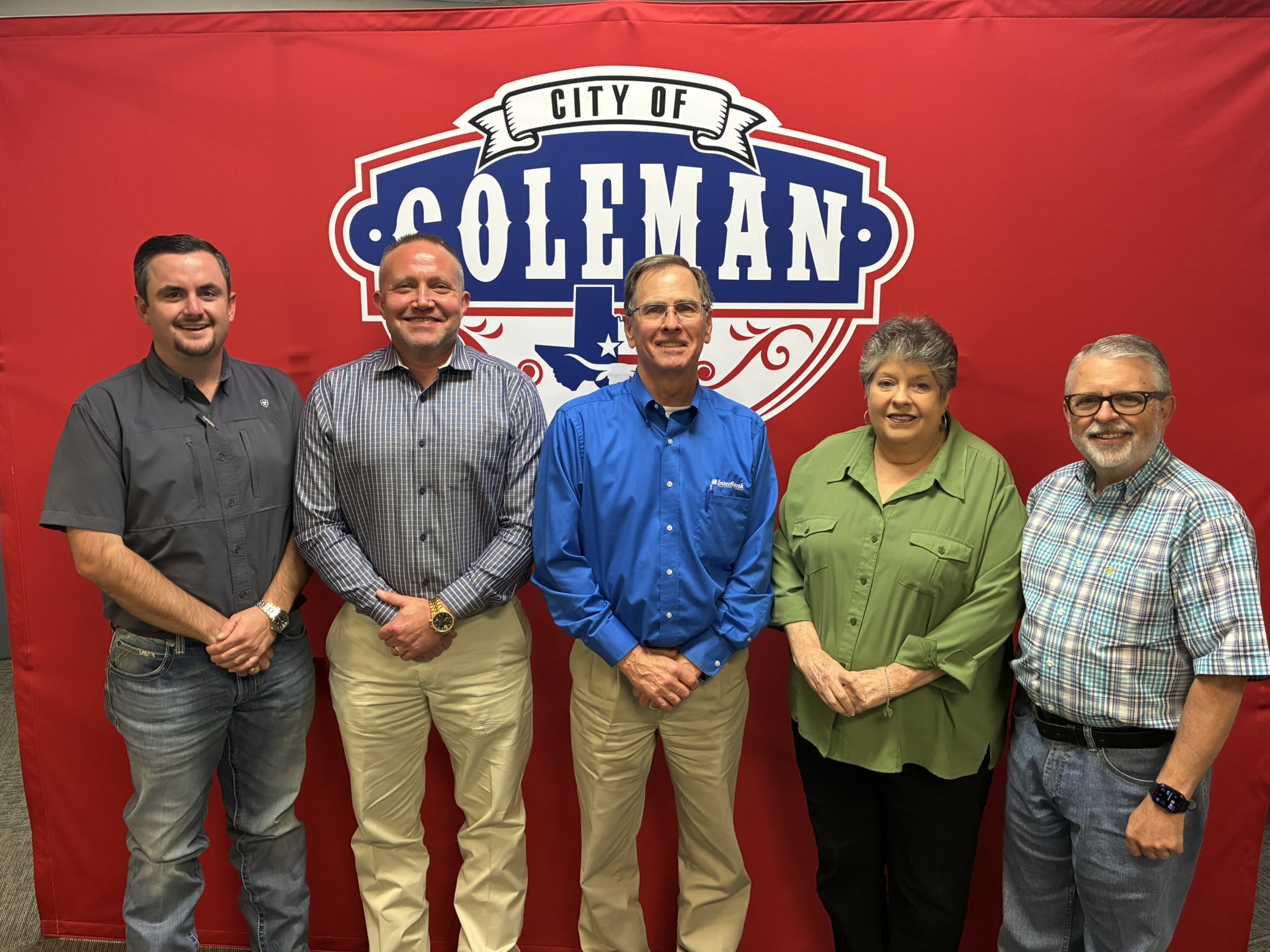 the 2026 City Council standing infront of a red background with City of Coleman logo